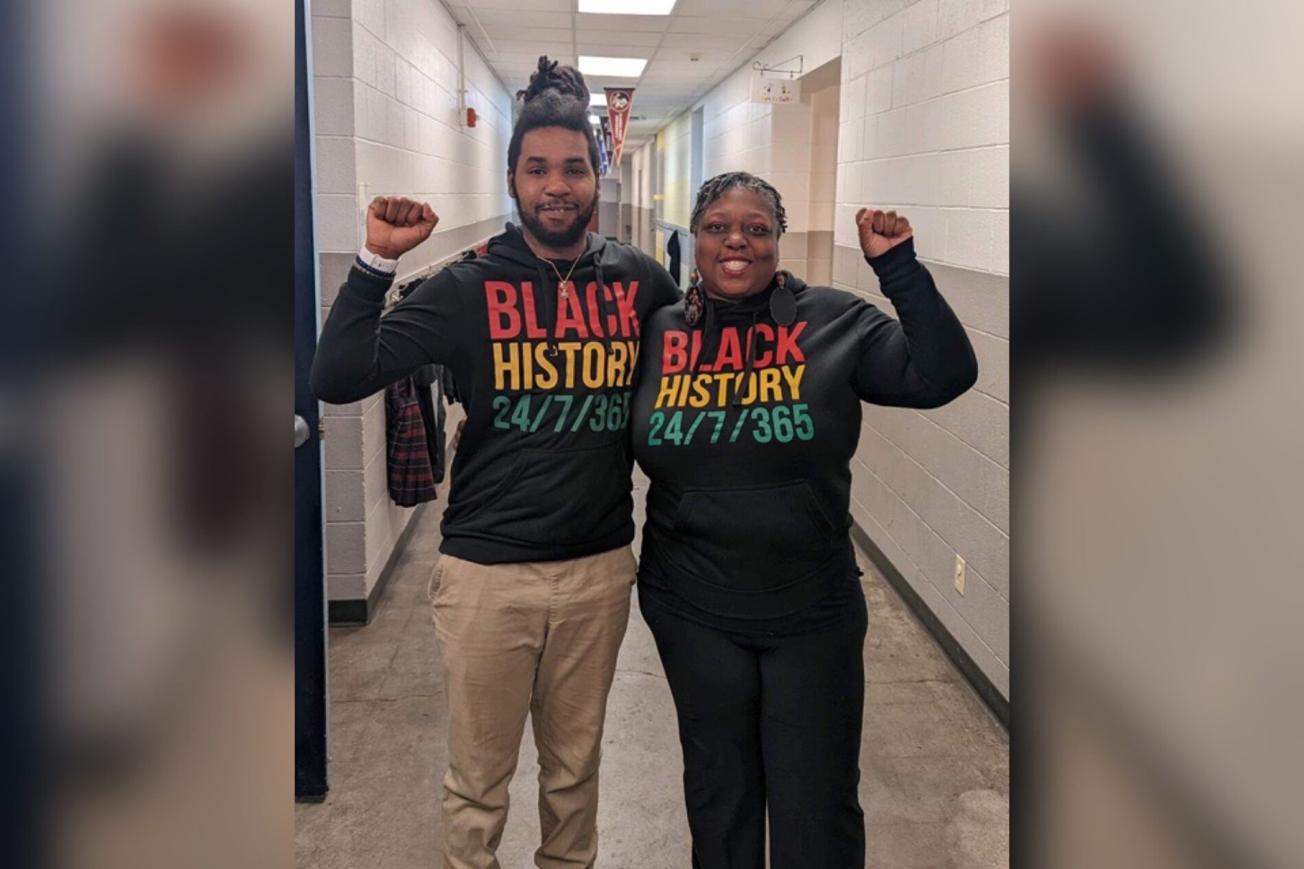 Mr. Ferguson with friend in hallway wearing colorful Black History tshirt.